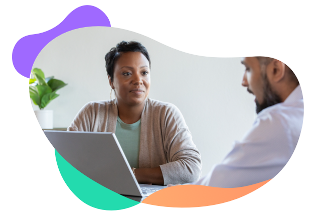 Young man and woman having a conversation in front of a laptop