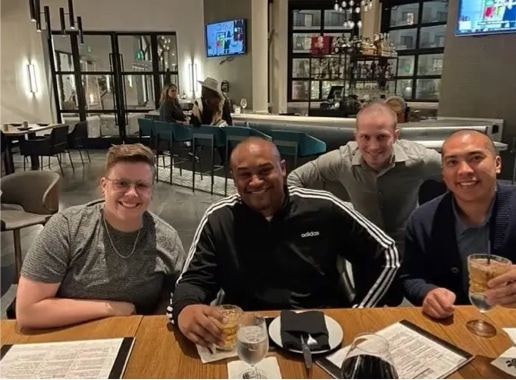 Four Kipu employees posing for photo at a restaurant